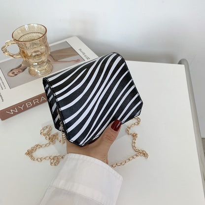 Damenmode Koreanische Version der Lippenstifttasche im westlichen Stil mit Kuhmusterkette